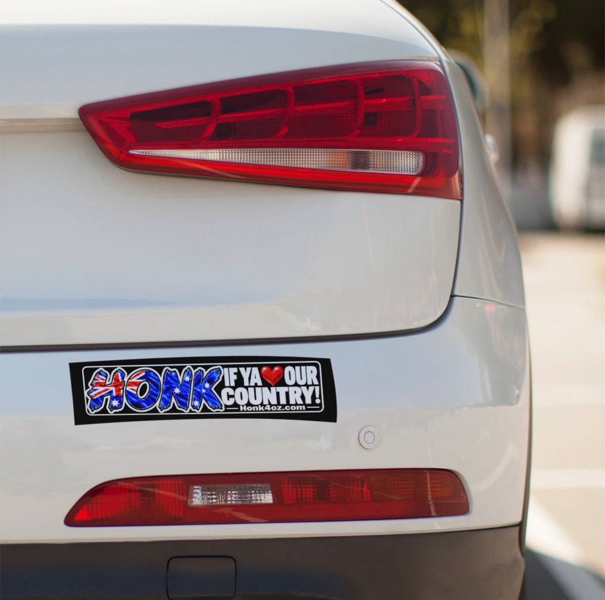 Honk if ya love our country bumper sticker on a white car